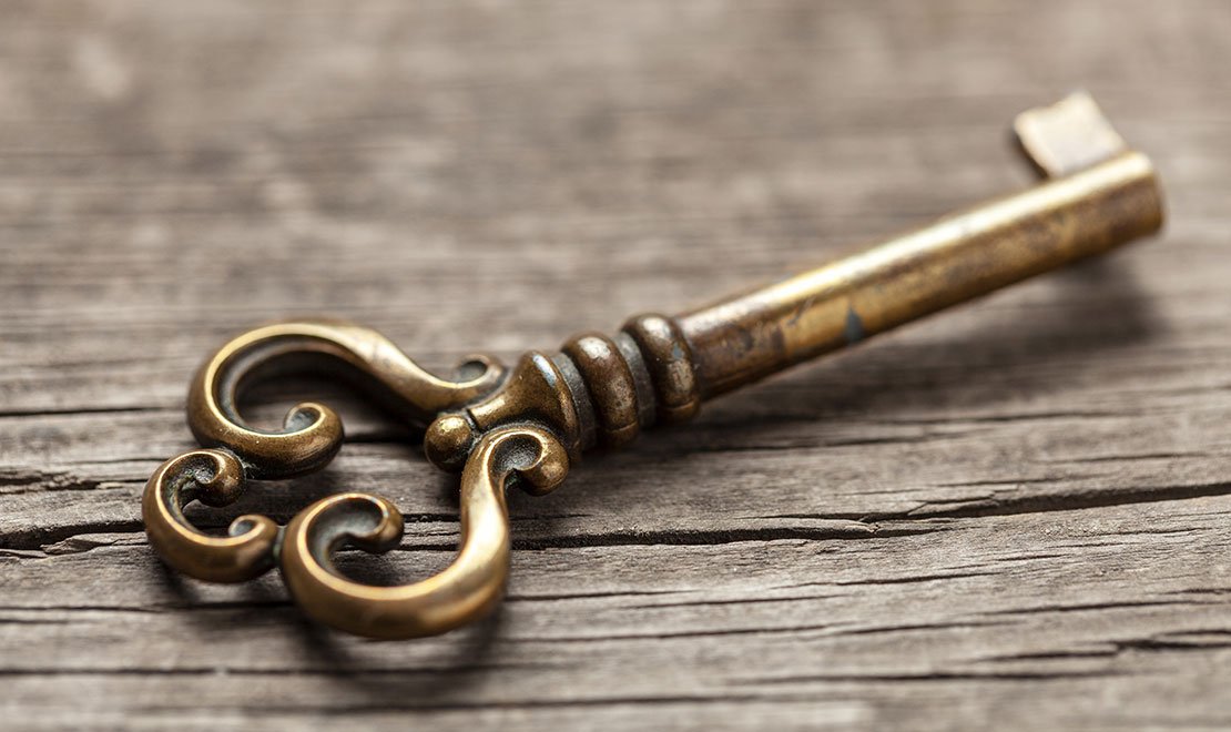 Aged brass key with an antique patina finish