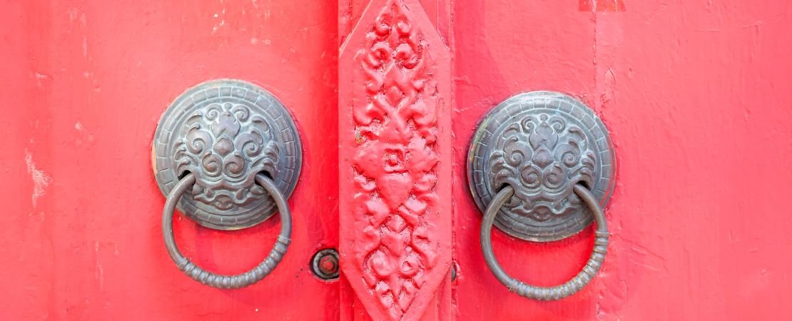 vintage knobbs side by side on red doors