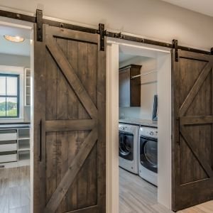rolling barn doors in front of laundry and mudroom